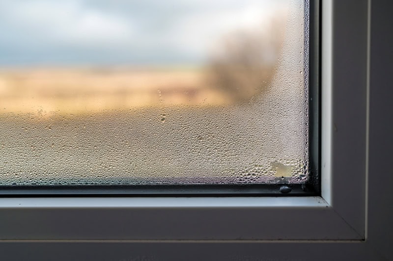 Ductless ACs Improve Indoor Air Quality and Control Humidity. Photo of a window with condensation.