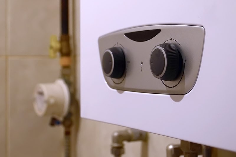 Close up photo of knobs on a water heater.
